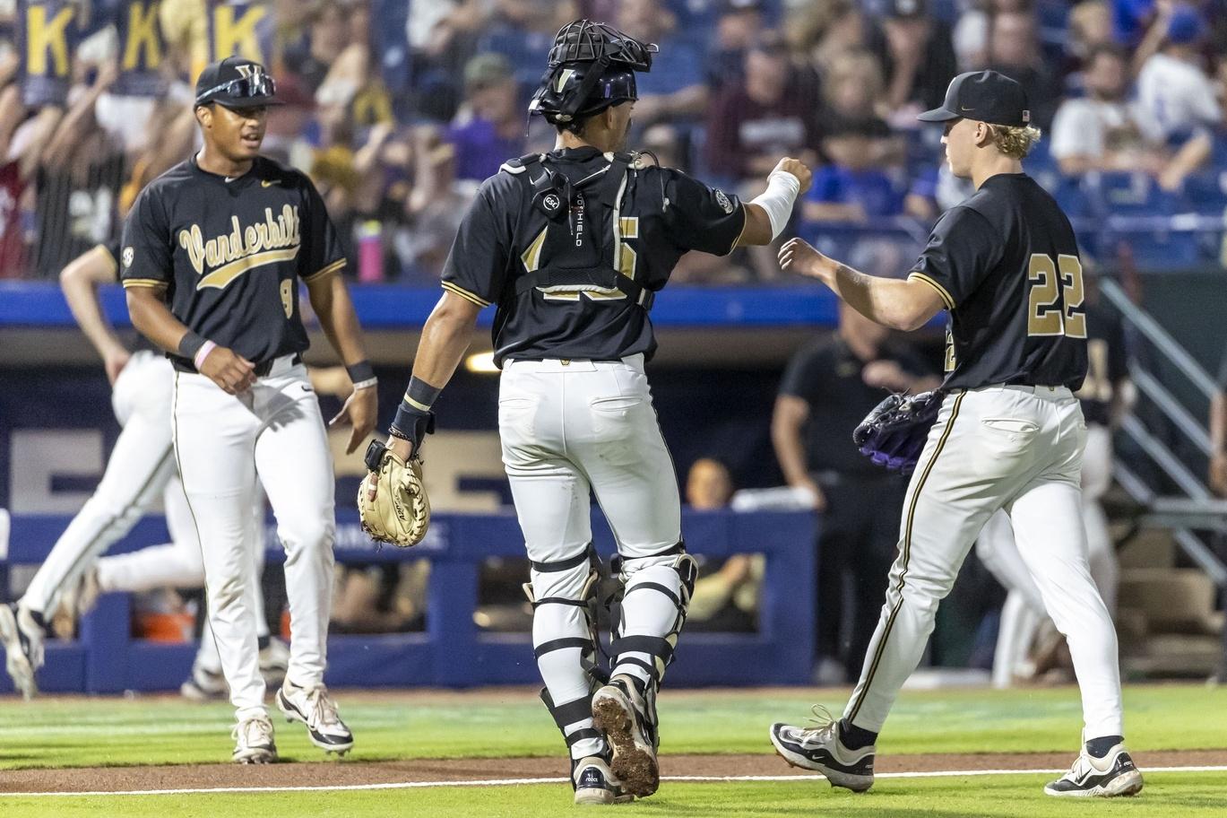 Vanderbilt players Alan Espinal (middle) and JD Thompson (right) fist bump